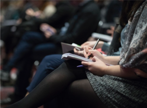 taking notes during an employee benefits meeting